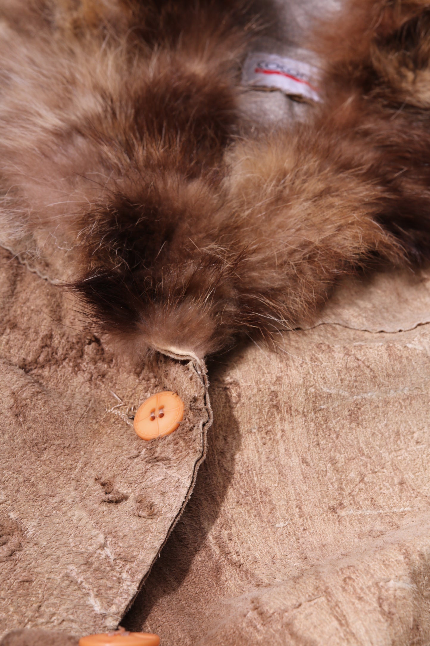 Extra long discarded leather coat with fur collar